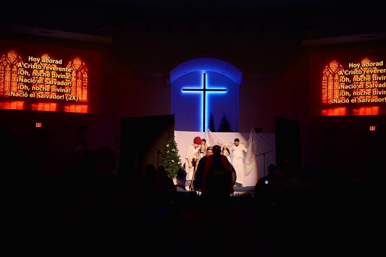 Worship service with congregation and illuminated cross